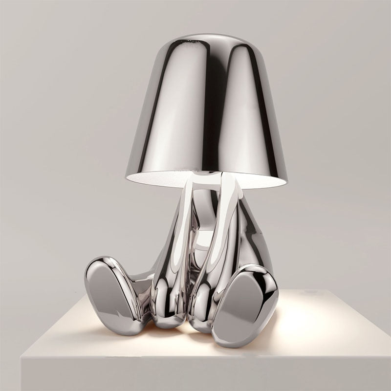 Reflective Metallic Table Lamp With Sculptural Seated Base And Dome Shade