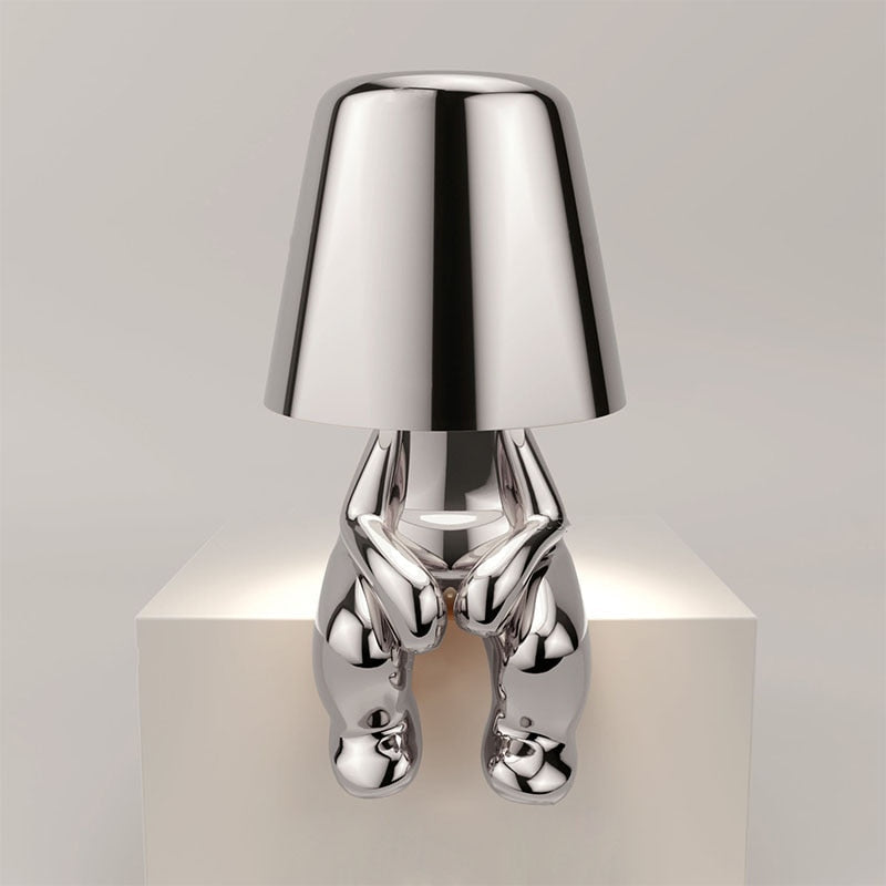 Reflective Metallic Table Lamp With Sculptural Seated Base And Dome Shade